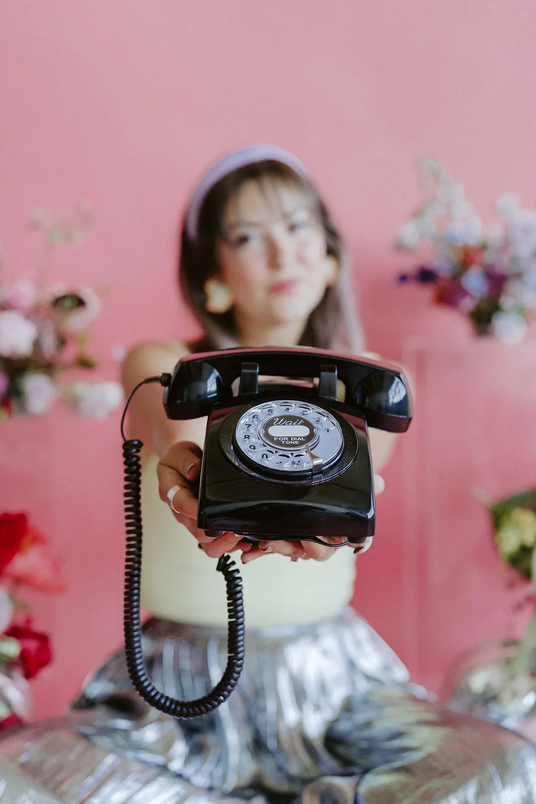 Marcus answering the audio guestbook phone against a pink backdrop