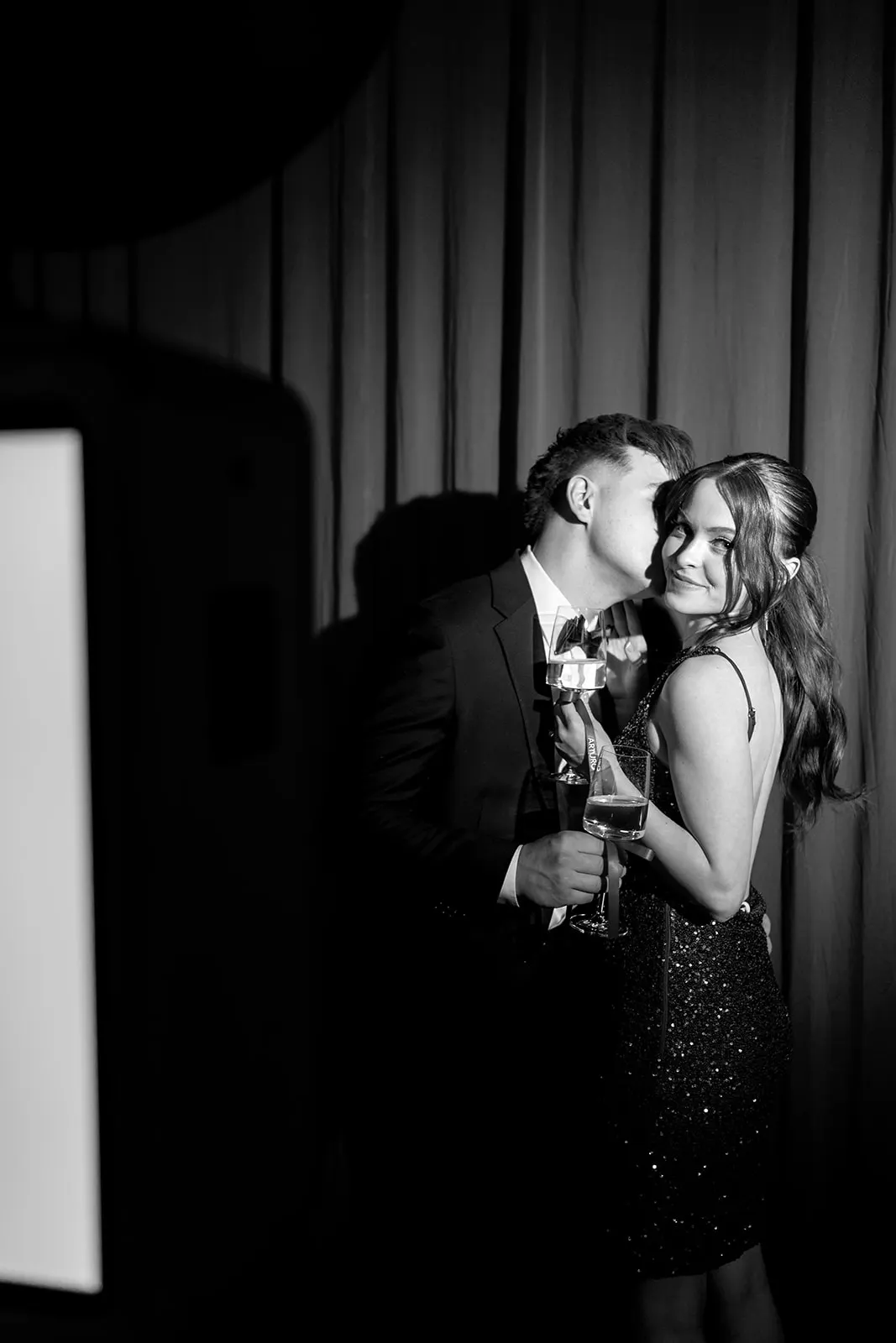 Guests laughing beside the booth at a San Diego wedding reception