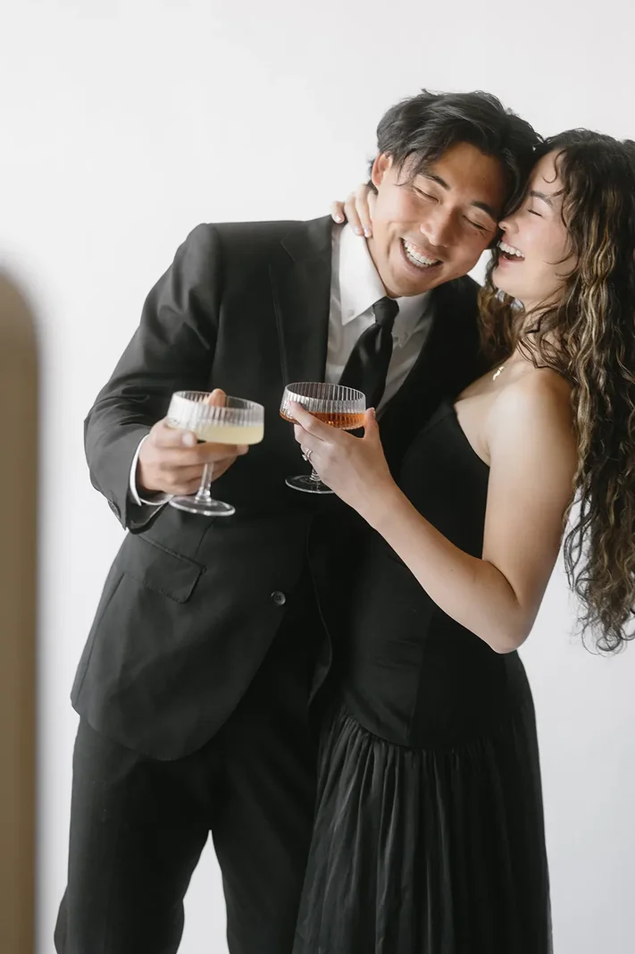 Two guests toasting in front of the booth at a historic hotel